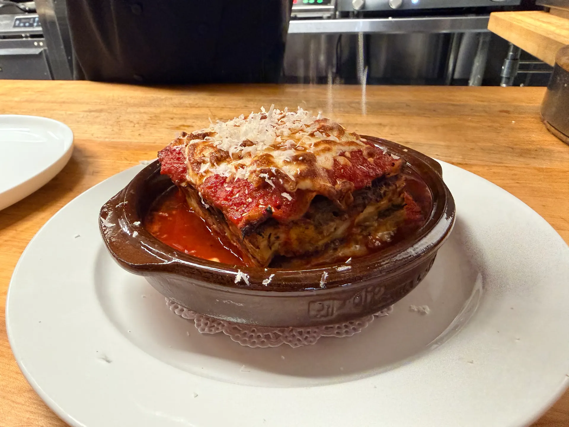 Lasagna bolognese in clay pot